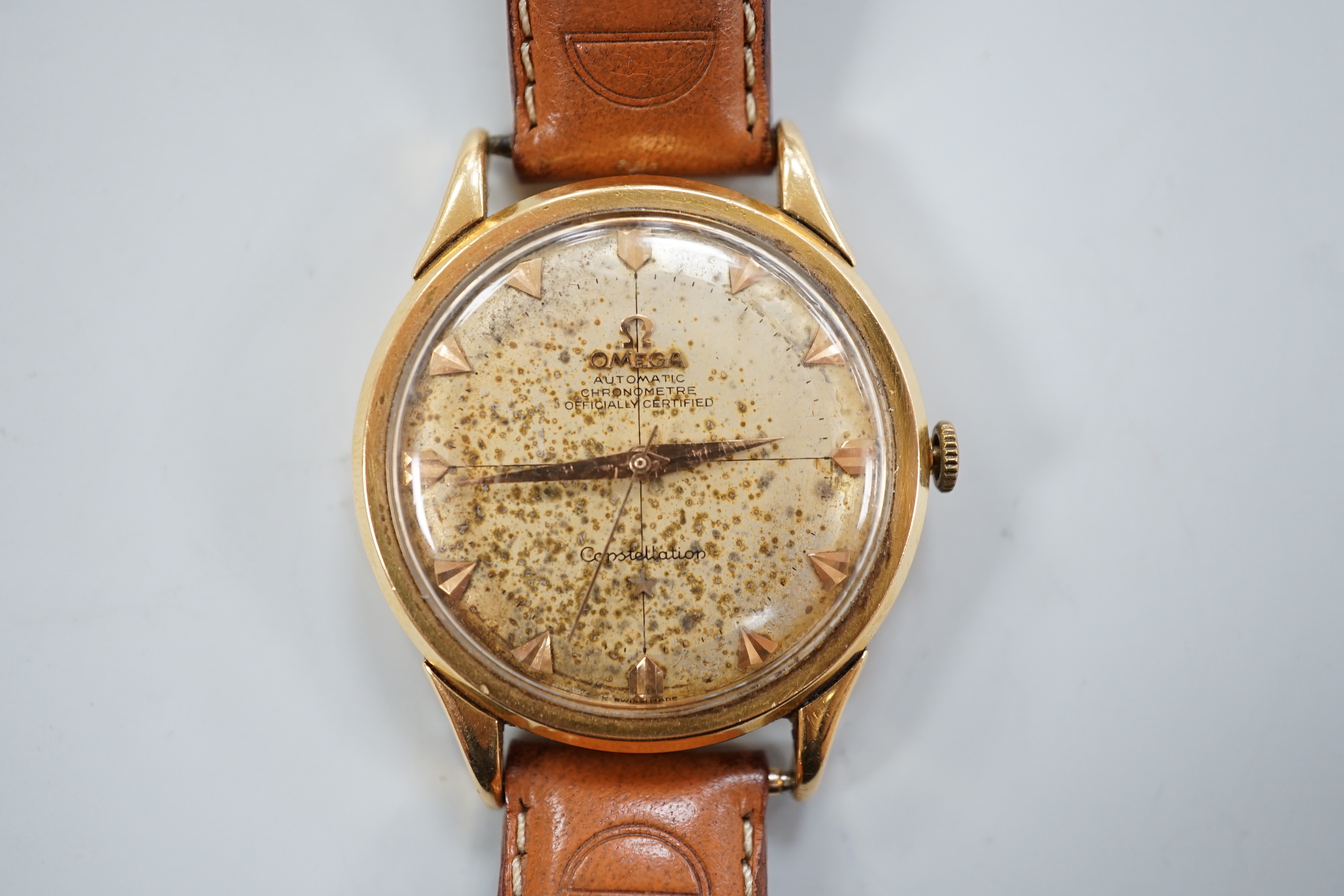 A gentleman's 1950's yellow metal (French 18ct poincon mark) Omega Constellation automatic wrist watch, on associated strap, case diameter 35mm, dial a.f.